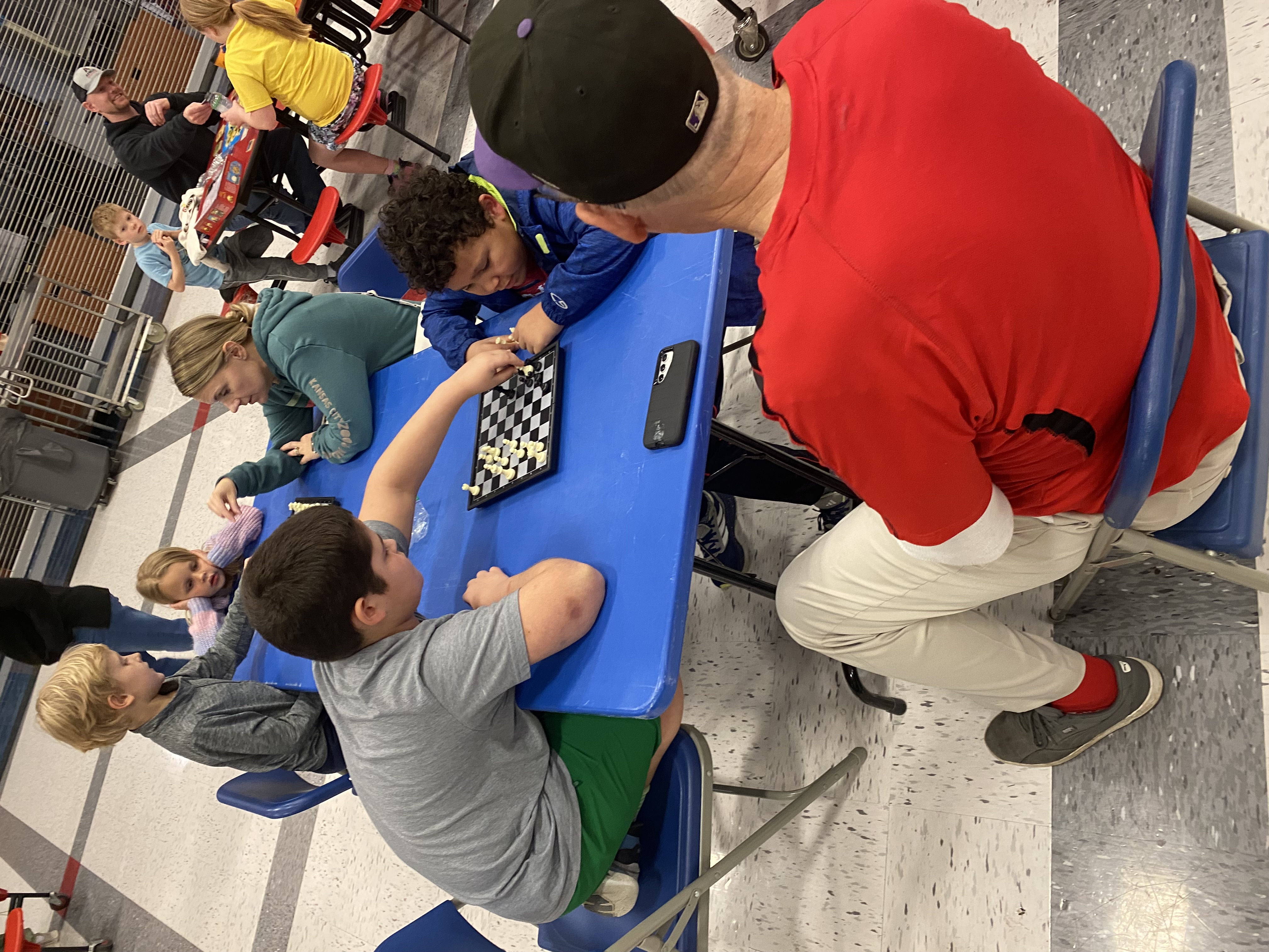 Family playing chess at the Horizons Family Night