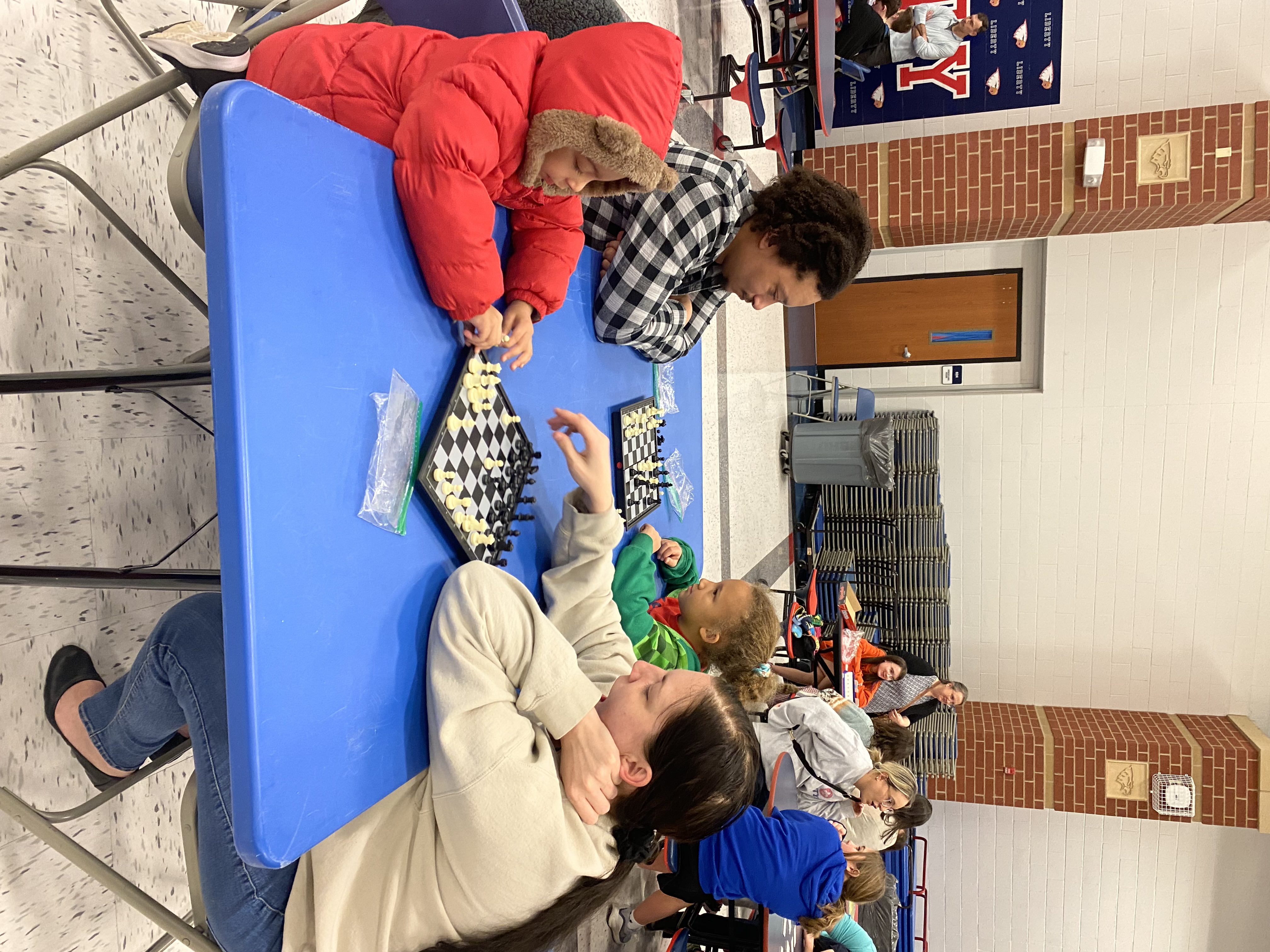 Family playing chess at the Horizons Family Night