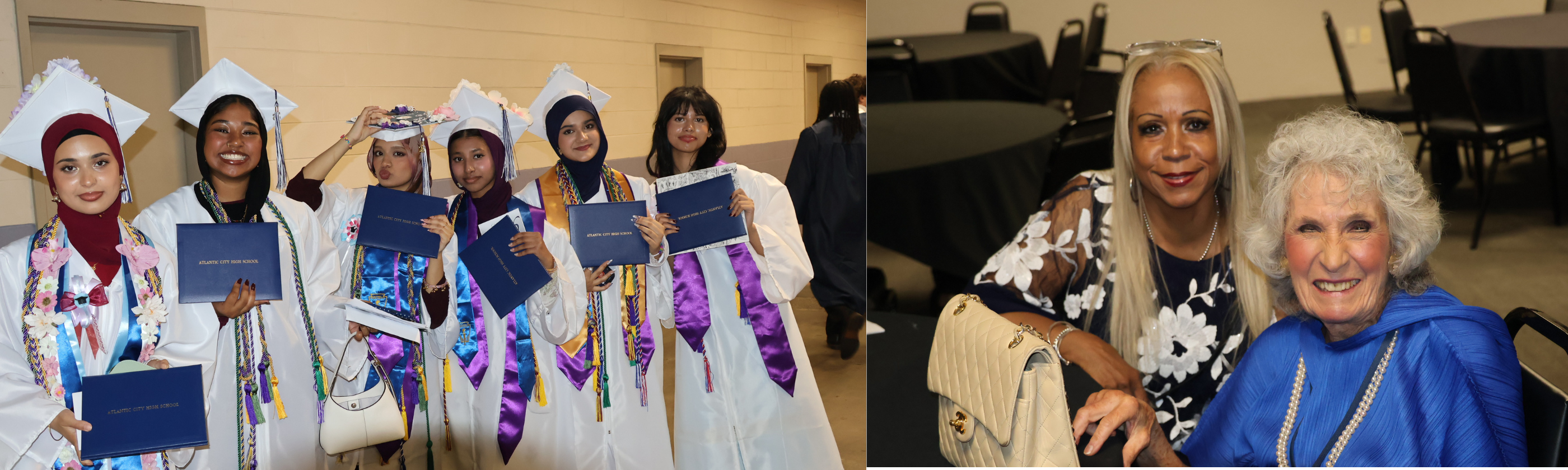 A group of graduates in caps and gowns pose with their diplomas in the foreground, while two women smile at the camera in the background.