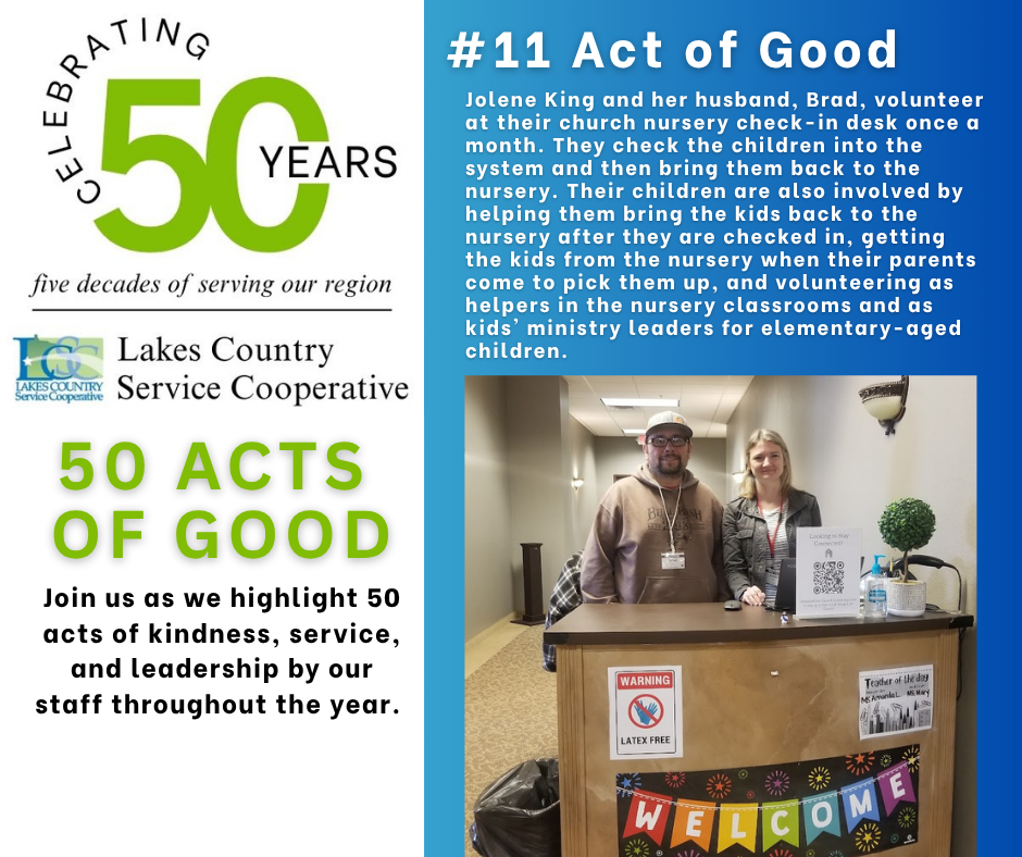 A man and woman stand behind a check-in desk in a hallway, with text about "50 Acts of Good" and "Celebrating 50 Years" on the left.