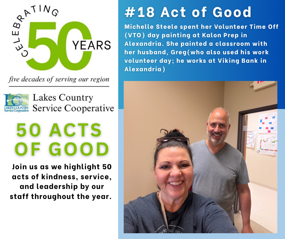 A smiling woman and man pose for a selfie in front of a classroom wall, with text about "50 Acts of Good" and "Celebrating 50 Years" on the left.