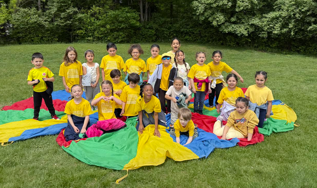 Students play with a parachute in field games.