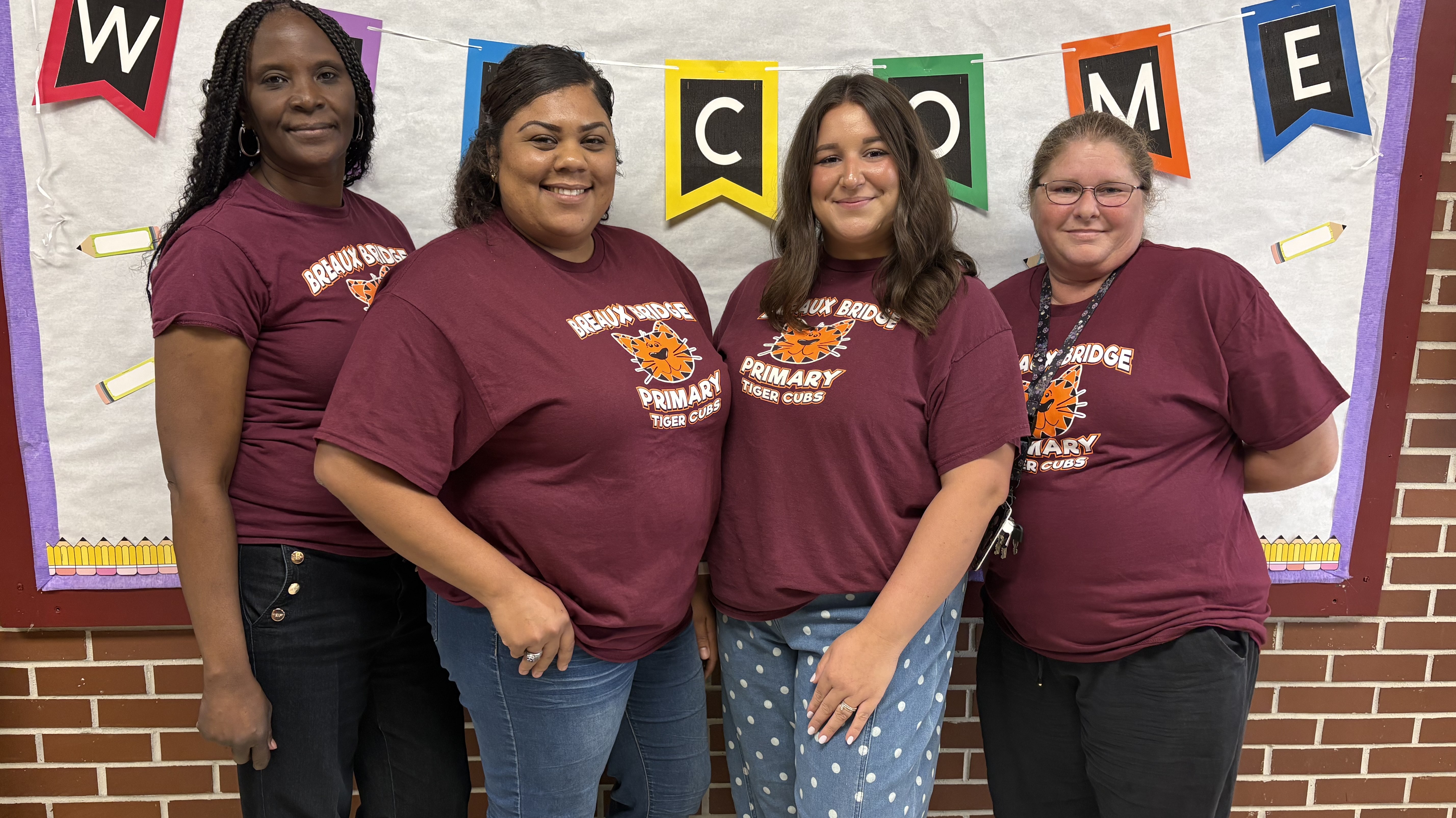 4 kindergarten teachers in front of the welcome sign
