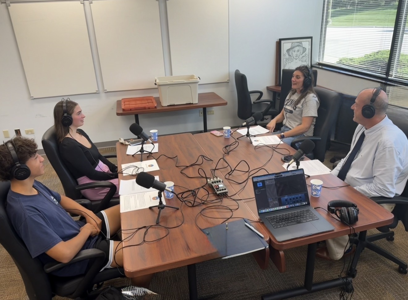 Four people recording the Sept. D128 Voices Podcast