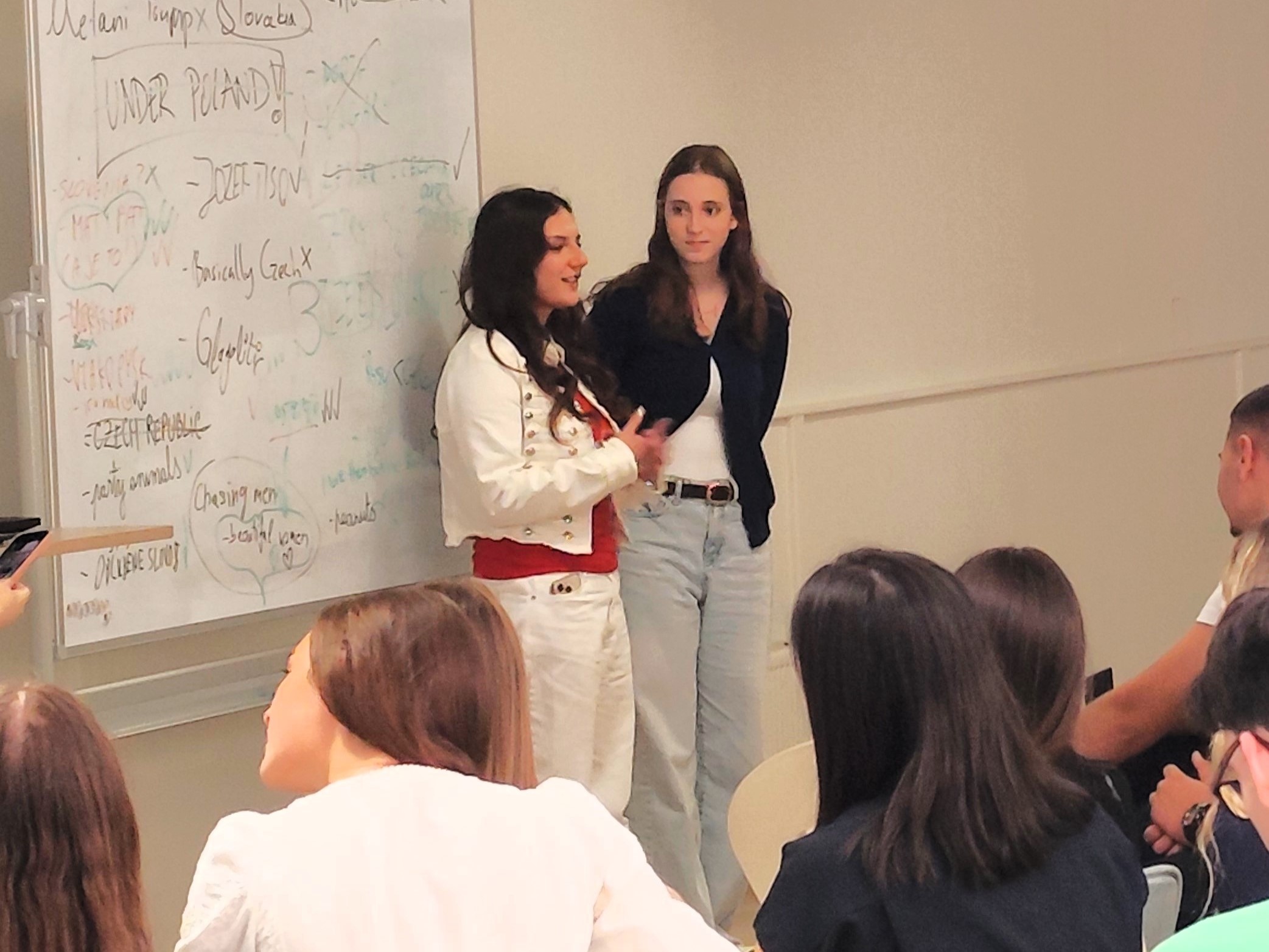 Students presenting ideas at a whiteboard during a workshop