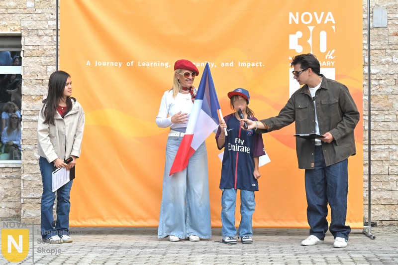 Parent and child holding the French flag at the Parade of Nations
