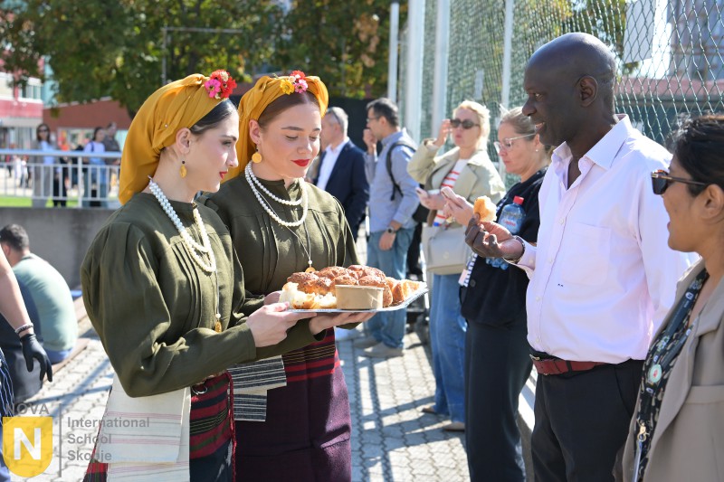 Women in traditional costume offering bread at the Parade of Nations