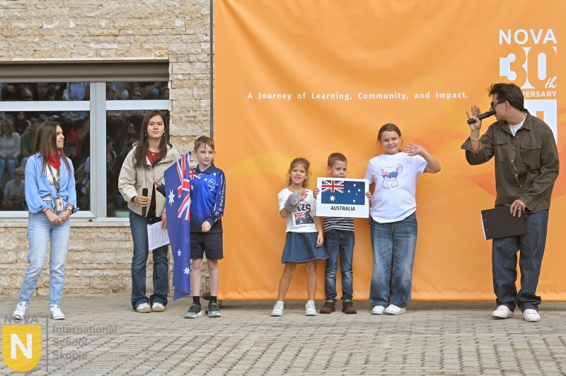 Family holding the Australian flag at the Parade of Nations