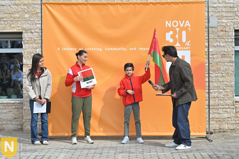 Parent and child holding a country sign at the Parade of Nations