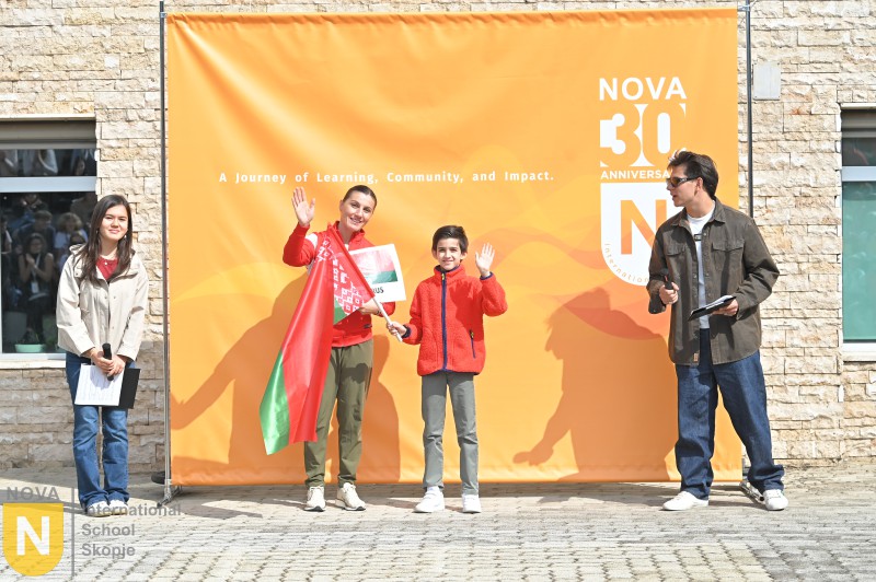 Parent and child waving a flag at the Parade of Nations