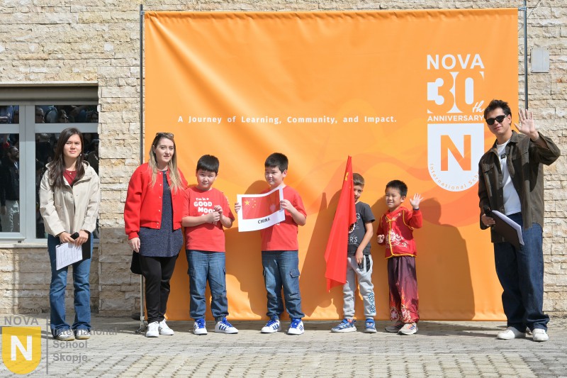 Family with children holding flags at the Parade of Nations