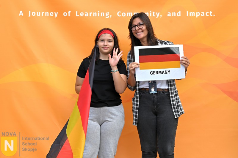 Student holding a flag and country sign at the Parade of Nations
