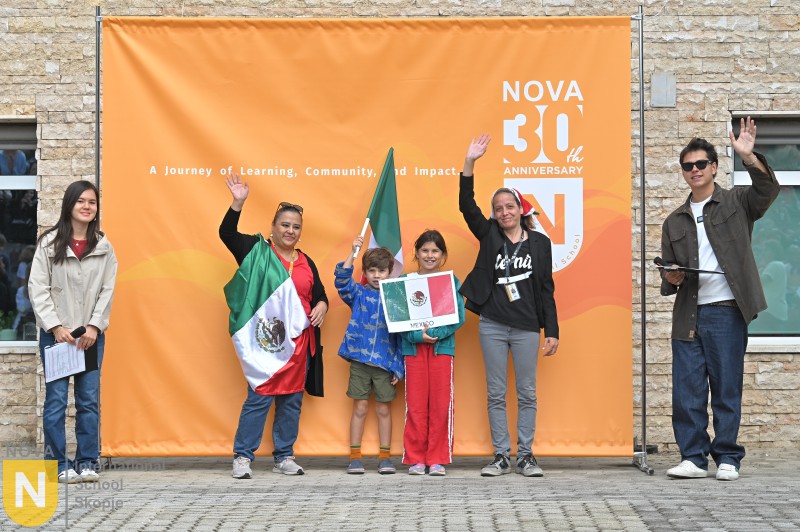 Family holding the Mexican flag at the Parade of Nations