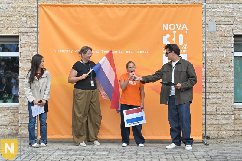 Family holding the Dutch flag at the Parade of Nations