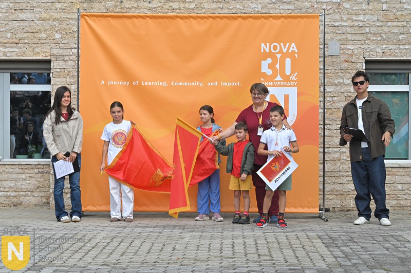 Students waving red flags at the Parade of Nations