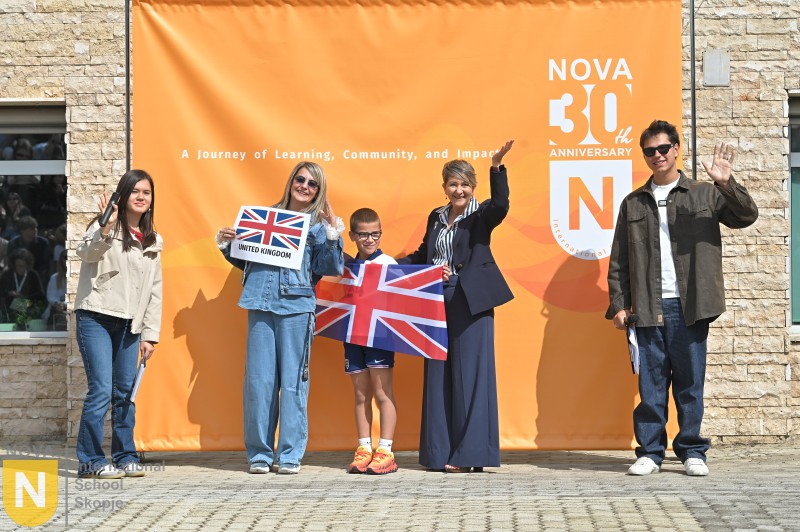 Family holding the United Kingdom flag at the Parade of Nations