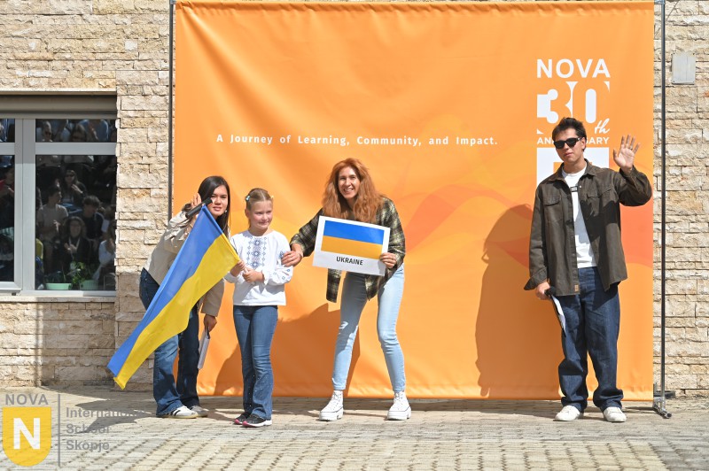 Family holding the Ukrainian flag at the Parade of Nations
