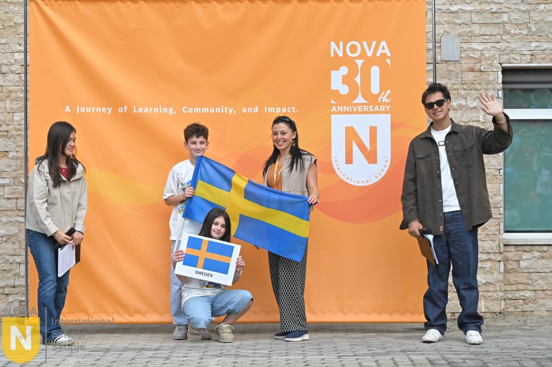 Family holding the Swedish flag at the Parade of Nations