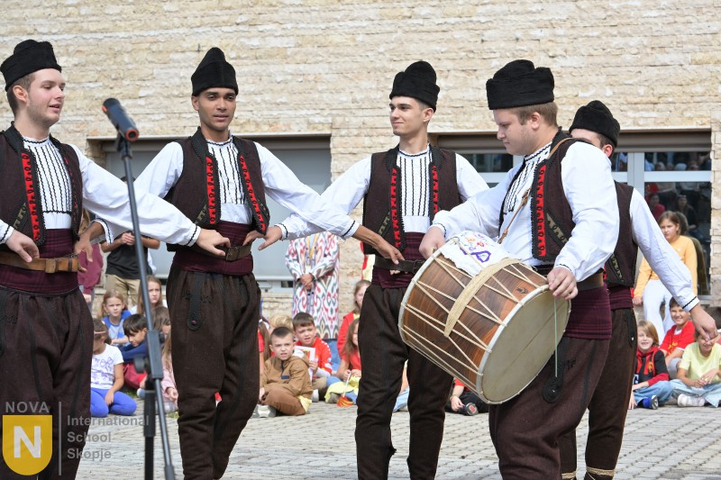 Folk musicians in traditional Macedonian costume singing and drumming