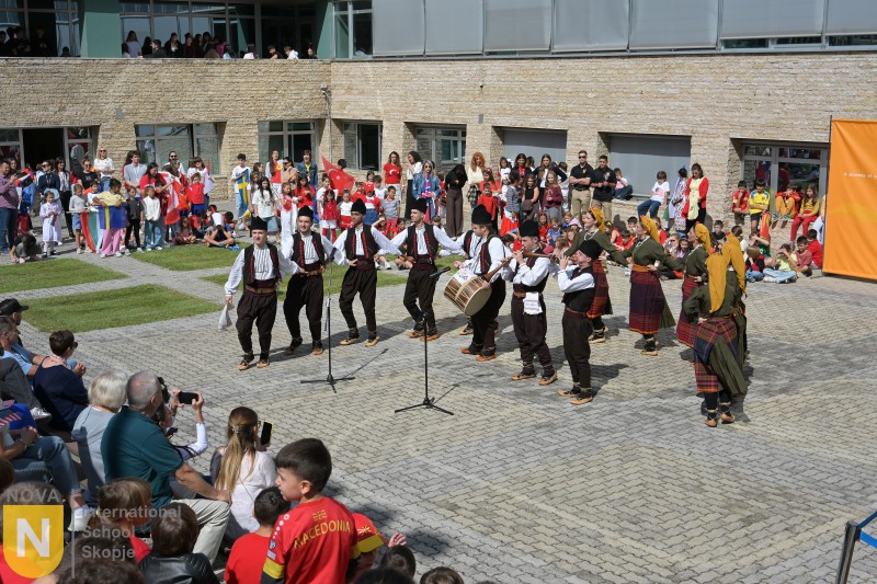 Traditional folk dance performance watched by students and families