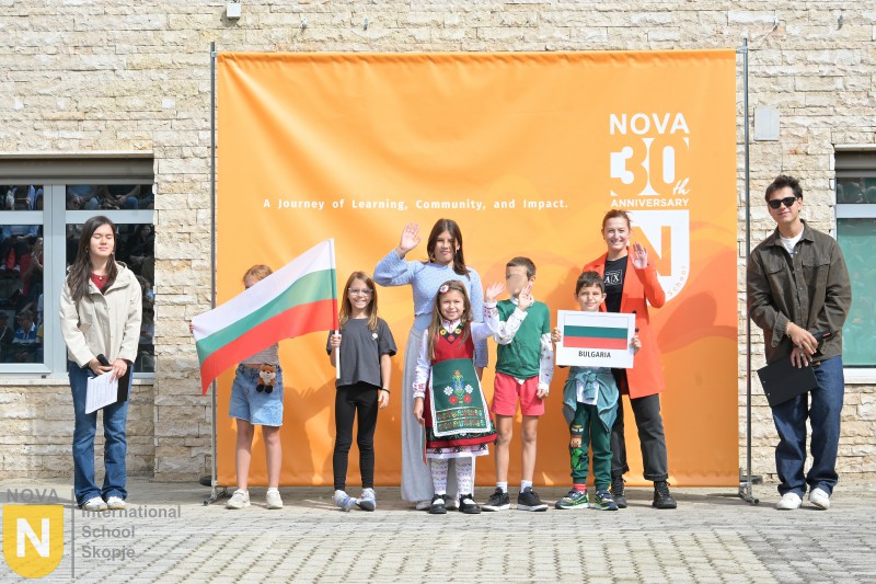 Family holding the Bulgarian flag at the Parade of Nations