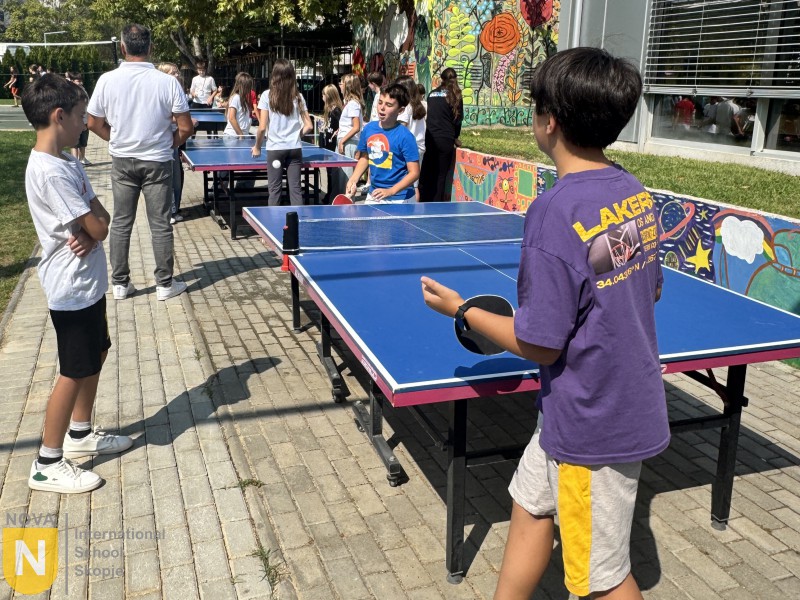 Students playing table tennis outdoors during House Pride events