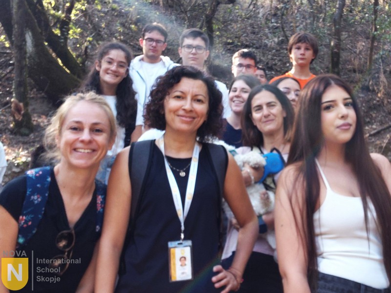 Teachers and students taking a group selfie outdoors