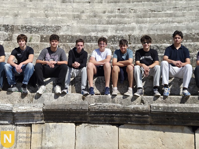Students sitting on the stone steps of an ancient theater