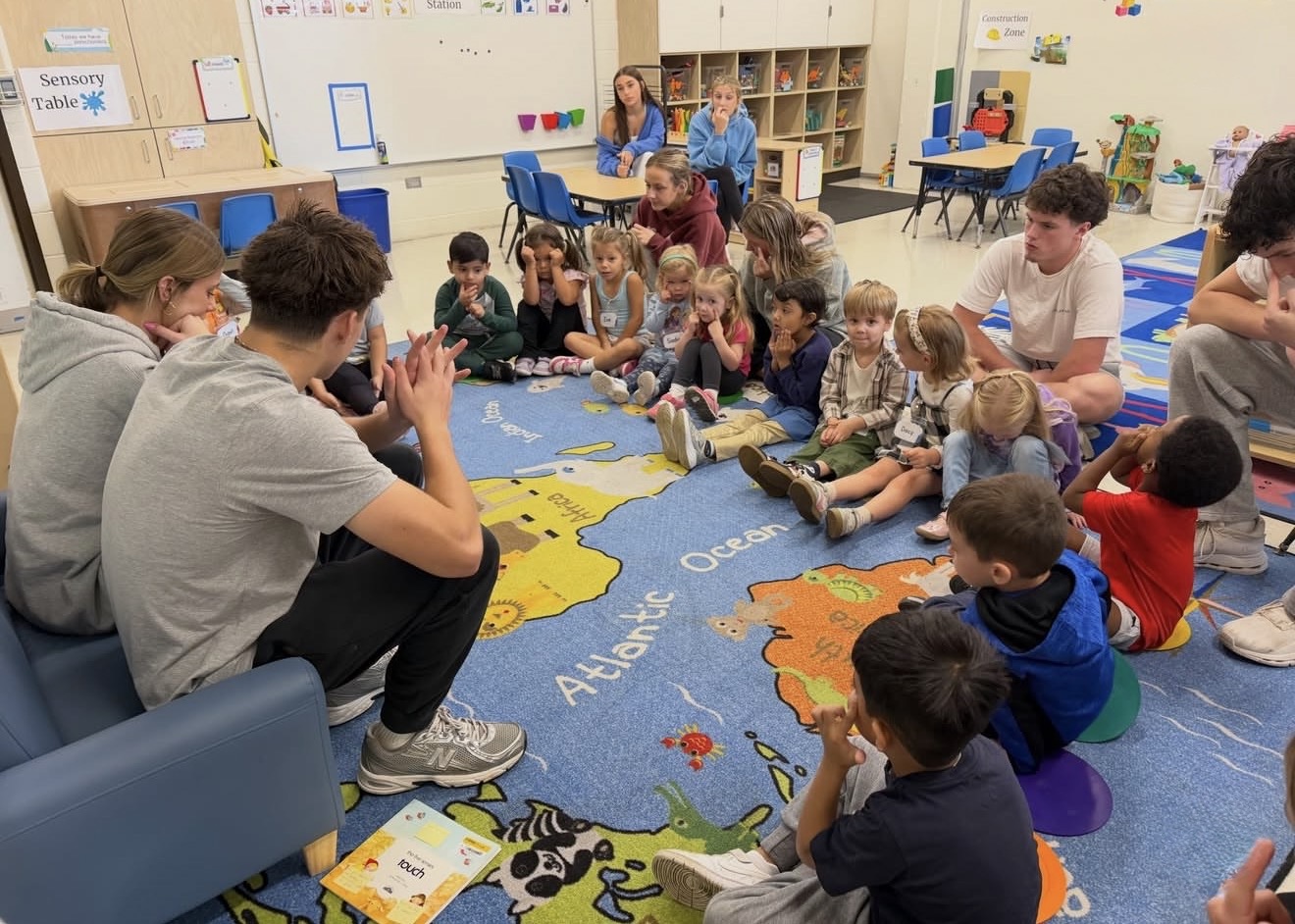 High school students doing an activity with preschool class at LHS